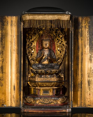 A LACQUERED WOOD ZUSHI (PORTABLE SHRINE) WITH SEATED KANNON, WITH A BUILT-IN ‘ILLUMINATING LIGHT’, 18TH CENTURY