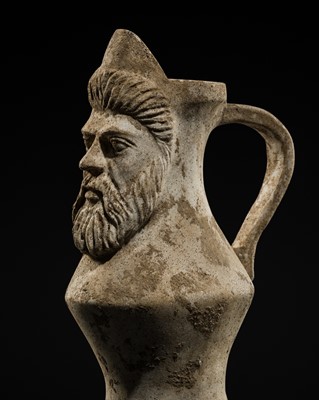 Lot 302 - A COMPOSITE STONE WINE JAR WITH HUMAN FACE, EASTERN MEDITERRANEAN / LEVANT, POSSIBLY ROMAN, CIRCA 1ST–2ND CENTURY AD