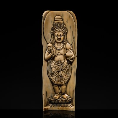 Lot 20 - A RARE CARVED IVORY TANTRIC RITUAL APRON ORNAMENT DEPICTING AVALOKITESHVARA, TIBET OR NEPAL, 18TH-19TH CENTURY