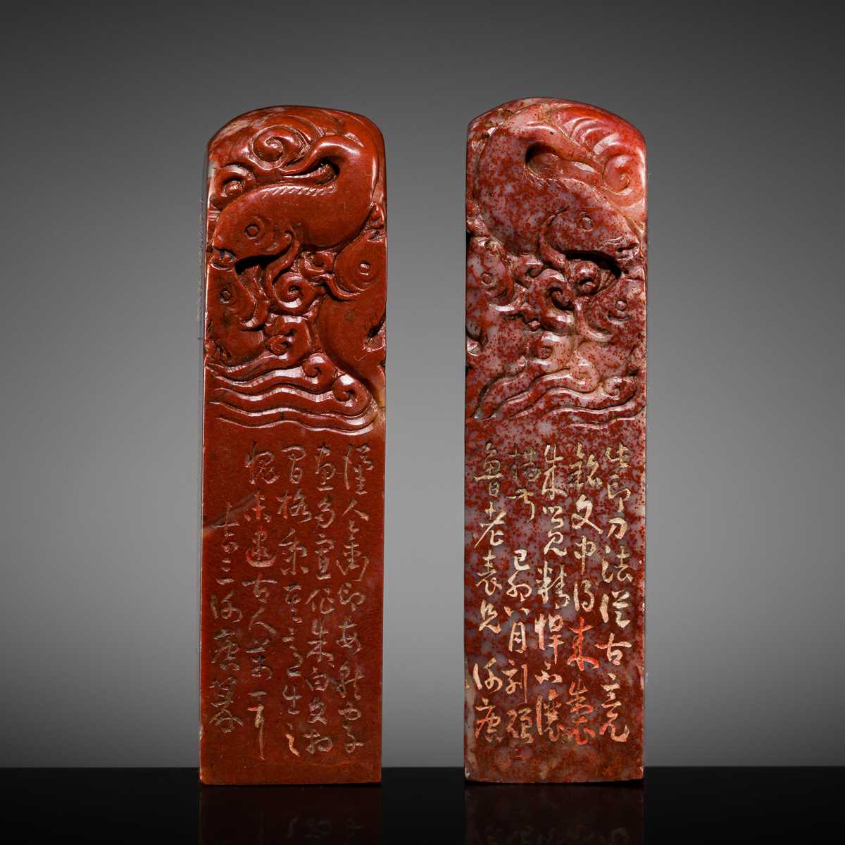 A FINE PAIR OF ‘CHICKEN BLOOD’ SOAPSTONE SEALS BY HE TANG, DATED 1879