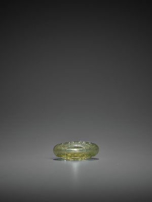 Lot 374 - A TRANSPARENT OLIVE-GREEN GLASS ‘TAOTIE’ SNUFF BOTTLE, QING DYNASTY