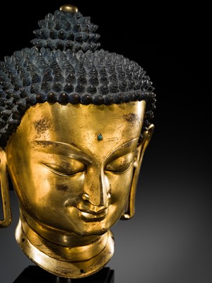 Lot 36 - THE MONUMENTAL AND UNIQUE ‘ULRICH VON SCHROEDER’ GILT-COPPER HEAD OF BUDDHA, TIBET, 14TH CENTURY