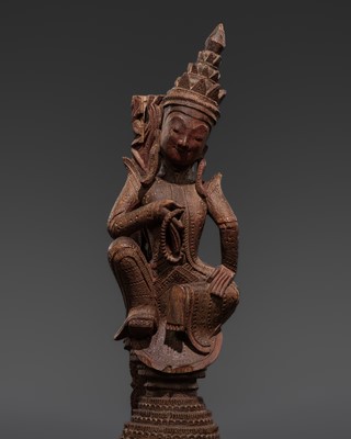 A RED-LACQUERED HARDWOOD ARCHITECTURAL FRAGMENT WITH A FEMALE DEITY
