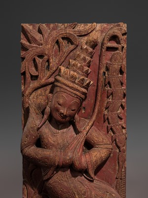 A LARGE RED-LACQUERED HARDWOOD ARCHITECTURAL FRAGMENT WITH A KNEELING FEMALE DEITY