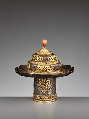 Lot 451 - A PARCEL-GILT SILVER REPOUSSÉ STEM-BOWL AND COVER, QING