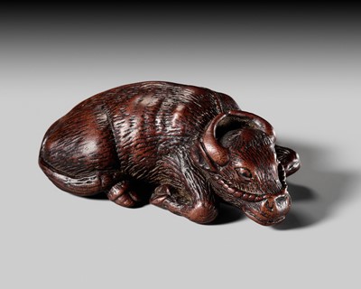 A LARGE AND BEGUILING WOOD NETSUKE OF AN OX