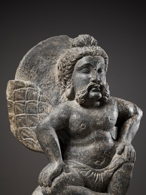 Lot 543 - A GRAY SCHIST FIGURE OF A WINGED ATLAS, GANDHARA