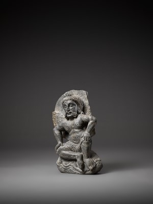 Lot 543 - A GRAY SCHIST FIGURE OF A WINGED ATLAS, GANDHARA