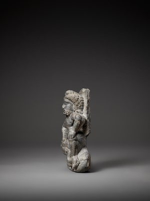 Lot 543 - A GRAY SCHIST FIGURE OF A WINGED ATLAS, GANDHARA