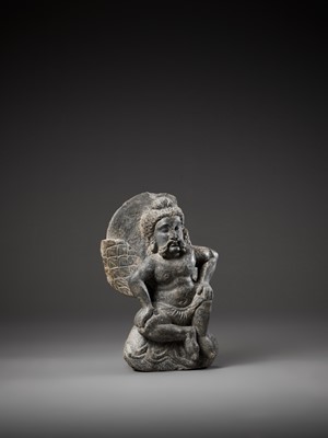 Lot 543 - A GRAY SCHIST FIGURE OF A WINGED ATLAS, GANDHARA