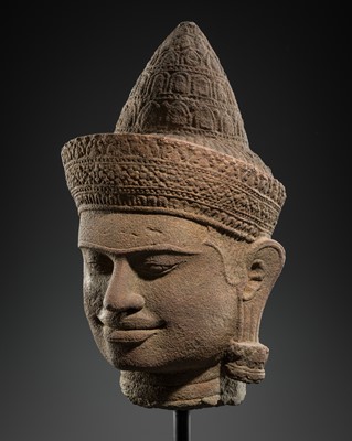 Lot 432 - A SANDSTONE HEAD OF A MALE DEITY, ANGKOR WAT STYLE, 12TH CENTURY