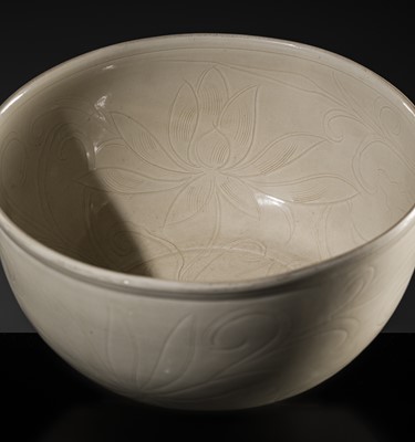 Lot 8 - A RARE AND MASTERFULLY CARVED LARGE 'DING' BOWL, NORTHERN SONG DYNASTY