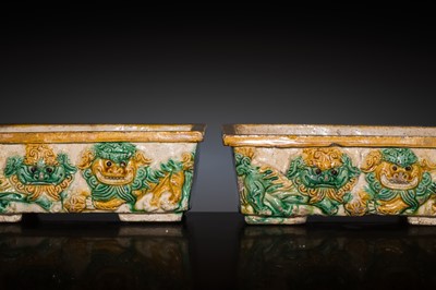 Lot 194 - A PAIR OF SANCAI-GLAZED STONEWARE ‘BUDDHIST LION’ PLANTERS, QING DYNASTY, KANGXI PERIOD