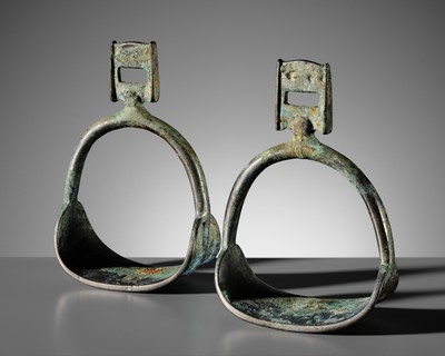 Lot 65 - A PAIR OF RARE SILVERED COPPER ALLOY STIRRUPS, TANG DYNASTY