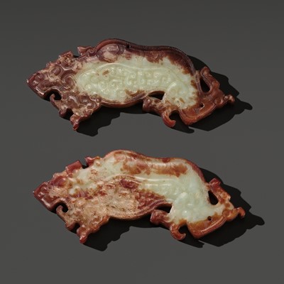 Lot 85 - A RARE AND MAGNIFICENT PAIR OF PALE CELADON AND RUSSET JADE ‘TIGER’ PENDANTS, WARRING STATES PERIOD TO WESTERN HAN DYNASTY