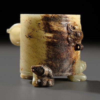 Lot 106 - A PALE CELADON AND RUSSET JADE WINE CUP, HAN DYNASTY