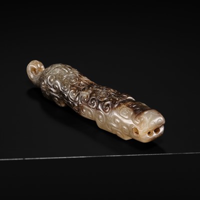 AN EXCEPTIONAL PALE CELADON AND BROWN JADE ‘TIGER’ PENDANT, SPRING AND AUTUMN PERIOD