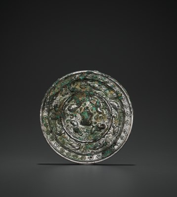 Lot 412 - A RARE SILVERED BRONZE ‘LIONS AND GRAPEVINES’ MIRROR, TANG