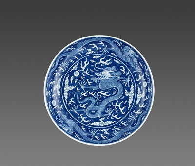 Lot 272 - A BLUE AND WHITE REVERSE-DECORATED “DRAGON” DISH, DAOGUANG MARK AND PERIOD