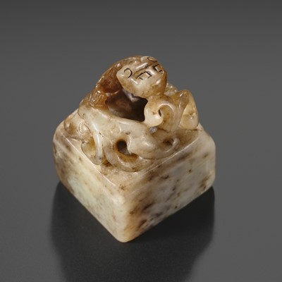Lot 271 - A WHITE AND BROWN JADE ‘CHILONG’ SEAL, QING DYNASTY