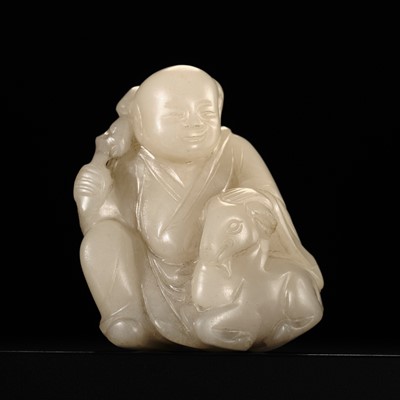 Lot 120 - A ‘MUTTON FAT’ JADE FIGURE OF A BOY WITH A RAM, QING DYNASTY