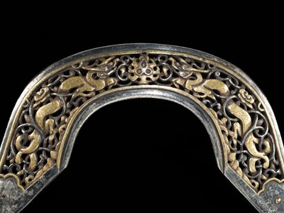 Lot 282 - A PARCEL-GILT IRON ‘DRAGON’ POMMEL PLATE FROM A HORSE SADDLE