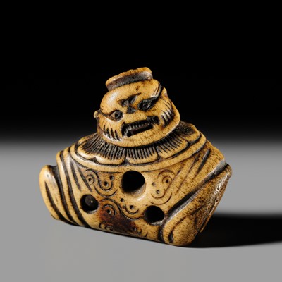 A RARE ANTLER ‘SILK SEAL’ TYPE NETSUKE OF A FOREIGNER