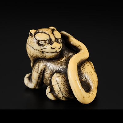 A FINE OSAKA SCHOOL IVORY NETSUKE OF A CROUCHING TIGER