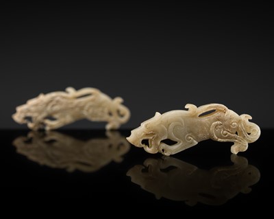 Lot 206 - A RARE PAIR OF MINIATURE WHITE JADE ‘TIGER’ PENDANTS, EASTERN ZHOU DYNASTY