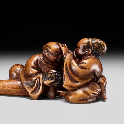 AN UNUSUAL AND RARE WOOD NETSUKE OF TWO EJI (TEMPLE SERVANTS)