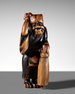 A GOOD LACQUERED WOOD NETSUKE OF ONI NO NEMBUTSU