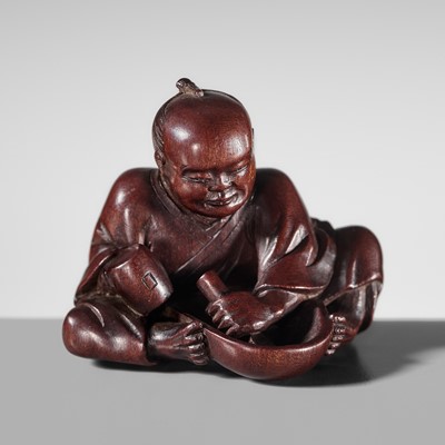 JUGYOKU: A FINE WOOD NETSUKE OF A MASK CARVER
