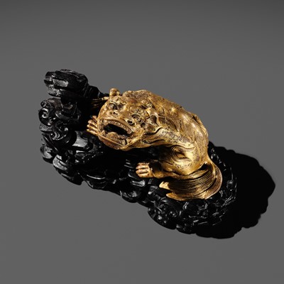 Lot 147 - A GILT BRONZE ‘LION’ WEIGHT WITH A MATCHING ZITAN BASE, CHINA, 16TH-17TH CENTURY