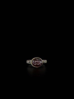 Lot 1254 - A PERSIAN BRONZE RING WITH RUBY INTAGLIO OF A HORSE, EX-COLLECTION MOHAMMAD REZA PAHLAVI
