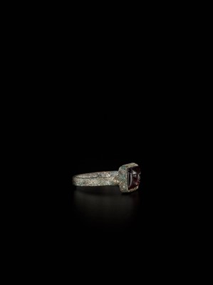 Lot 1255 - A PERSIAN BRONZE RING WITH RUBY INTAGLIO OF A LION, EX-COLLECTION MOHAMMAD REZA PAHLAVI