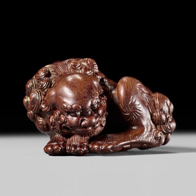 ITTO: A FINE WOOD NETSUKE OF A RECUMBENT SHISHI