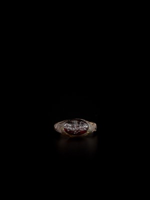 Lot 1257 - A PERSIAN BRONZE RING WITH RUBY INTAGLIO OF A MYTHICAL HORSE, EX-COLLECTION MOHAMMAD REZA PAHLAVI
