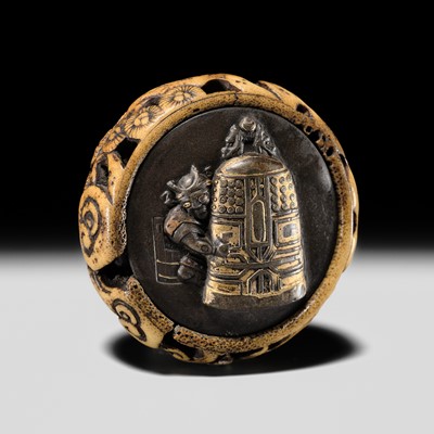 AN ANTLER AND SHIBUICHI KAGAMIBUTA NETSUKE OF AN ONI WITH A TEMPLE BELL