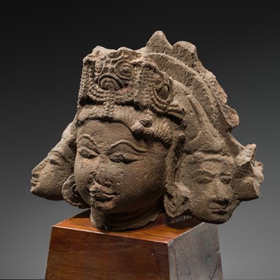 Lot 328 - A RED SANDSTONE HEAD OF BRAHMA TRIMURTI, RAJASTHAN OR MADHYA PRADESH, 10TH-11TH CENTURY