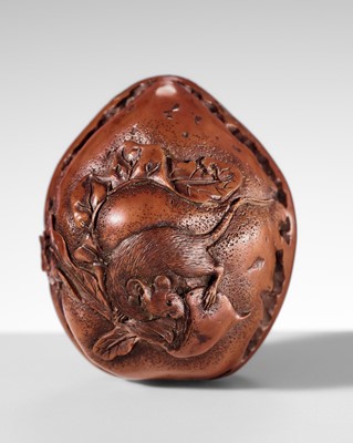 KOKUSUI: A RARE KURUMI (WALNUT) NETSUKE DEPICTING A RAT AND DAIKON