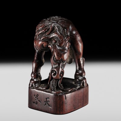 KARAKU: A RARE AND POWERFUL WOOD SEAL-TYPE NETSUKE OF A KIRIN
