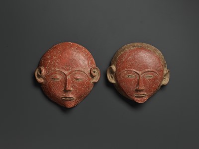 Lot 777 - A PAIR OF CERAMIC ANCESTRAL MASKS