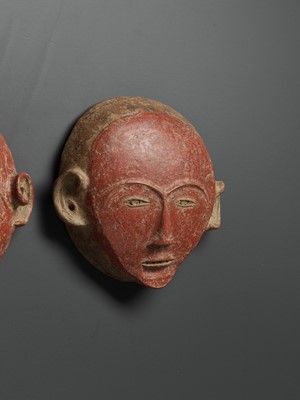 Lot 777 - A PAIR OF CERAMIC ANCESTRAL MASKS