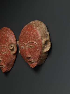Lot 777 - A PAIR OF CERAMIC ANCESTRAL MASKS