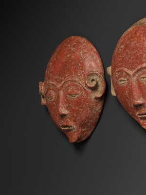 Lot 777 - A PAIR OF CERAMIC ANCESTRAL MASKS