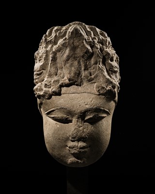 Lot 327 - A RARE MONUMENTAL BUFF SANDSTONE HEAD OF DEVI, UTTAR PRADESH, 9TH-10TH CENTURY