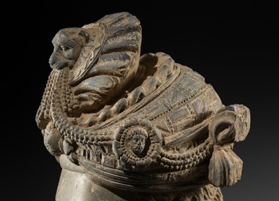 Lot 248 - A LARGE SCHIST HEAD OF A BODHISATTVA WITH A ‘KĪRTIMUKHA’ TURBAN, GANDHARA, 4TH–5TH CENTURY, FORMERLY IN THE COLLECTION OF BEGUM BAKHT ZEBA