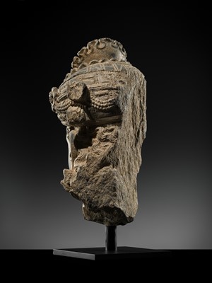 Lot 248 - A LARGE SCHIST HEAD OF A BODHISATTVA WITH A ‘KĪRTIMUKHA’ TURBAN, GANDHARA, 4TH–5TH CENTURY, FORMERLY IN THE COLLECTION OF BEGUM BAKHT ZEBA