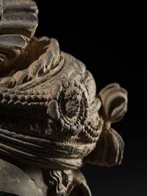 Lot 248 - A LARGE SCHIST HEAD OF A BODHISATTVA WITH A ‘KĪRTIMUKHA’ TURBAN, GANDHARA, 4TH–5TH CENTURY, FORMERLY IN THE COLLECTION OF BEGUM BAKHT ZEBA