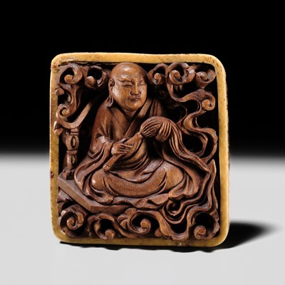 TOMOCHIKA: A RARE WOOD AND IVORY RYUSA NETSUKE OF A RAKAN (ARHAT)